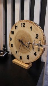 a wooden clock with a rope attached to it